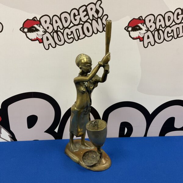 Antique African bronze figure of a lady holding a club.