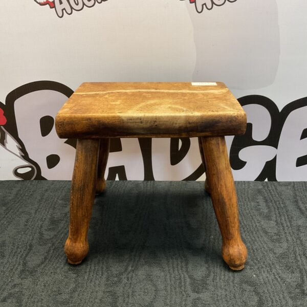 Vintage wooden gout stool with three legs.