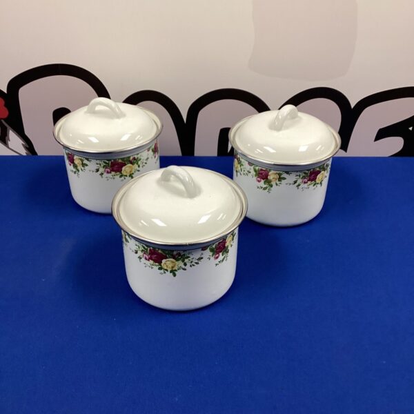 Group of three vintage Royal Albert storage jars with floral design.