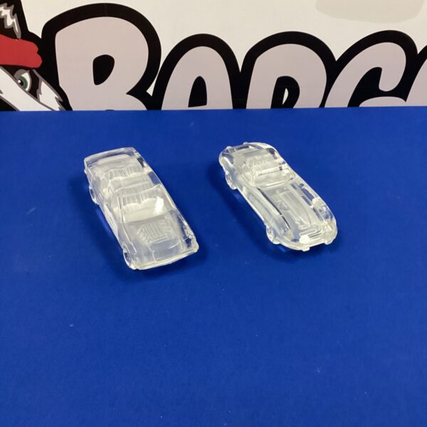 Two clear lead crystal E Type Jaguar car sculptures on display.