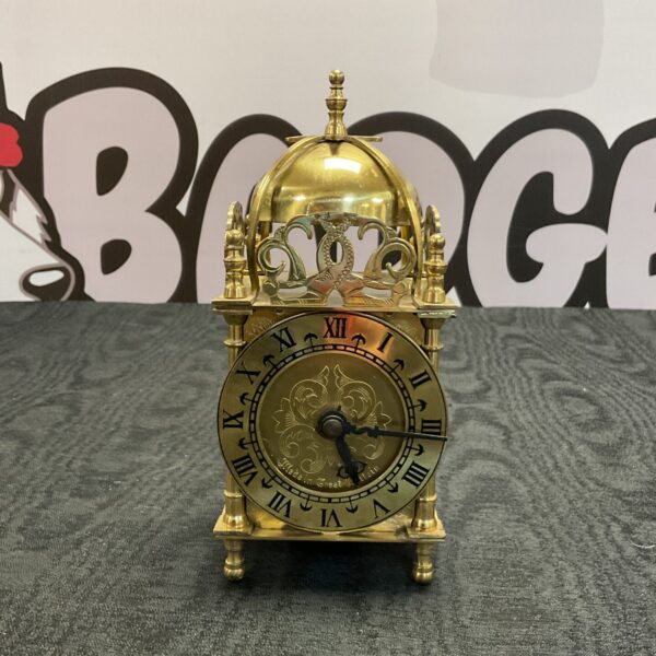 Vintage Smiths quartz carriage clock with brass case and Roman numerals.