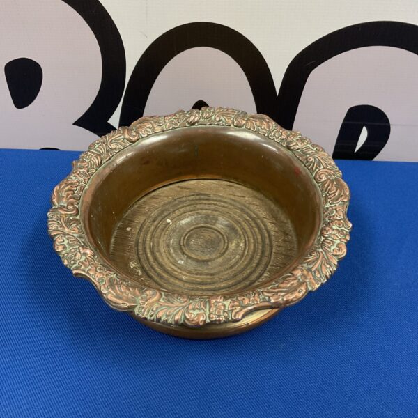 Antique Victorian copper wine coaster with floral detailing.