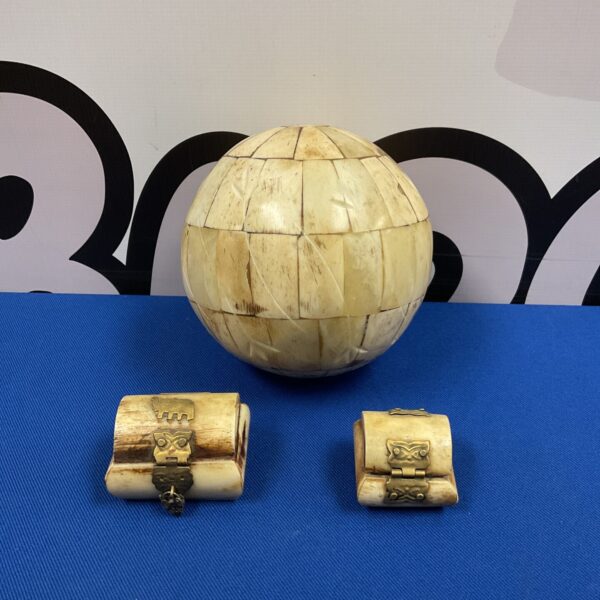 Intricate vintage bone ball and trinket pot with silver padlock.