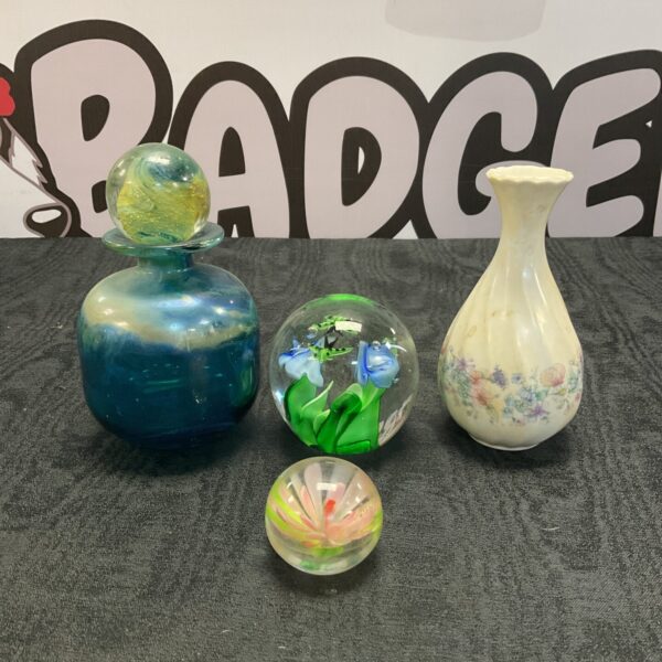 Vibrant blue glass paperweight and delicate Medina scent bottle collection.