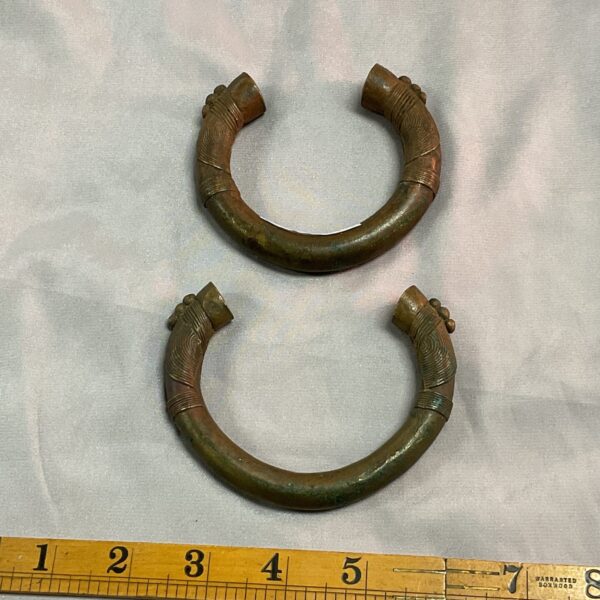 Pair of antique bronze slave bangles with textured detailing.