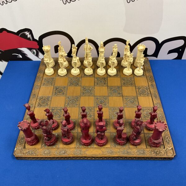 Antique Napoleon Wellington chess set on a rose patterned board.