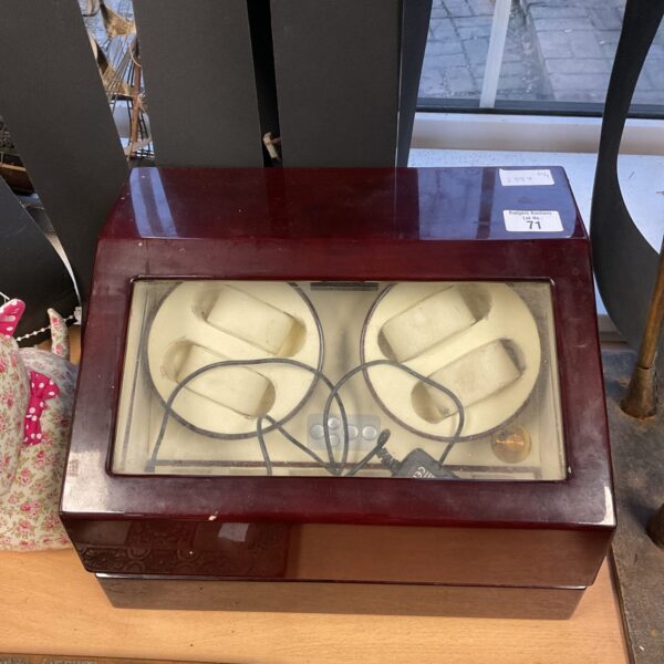 Vintage wooden automatic watch winder box for multiple timepieces.