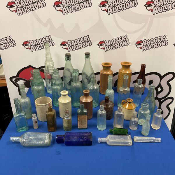 Antique bottle collection with various vintage glass bottles on display.
