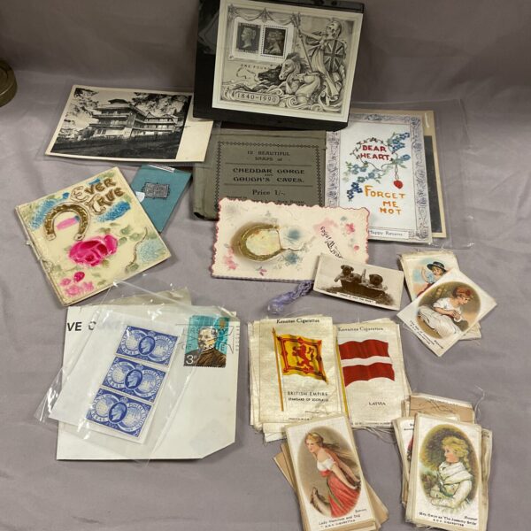 Vintage ephemera collection featuring antique silks and stamps.