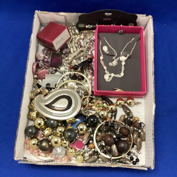Assorted costume jewellery tray with necklaces and bracelets.
