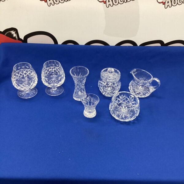 Vintage etched crystal brandy glasses with floral designs.