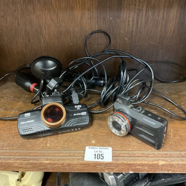 Pair of Nextbase car dash cams for vehicle recording and road safety.