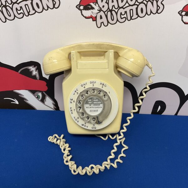 Vintage GPO rotary wall telephone in beige bakelite.
