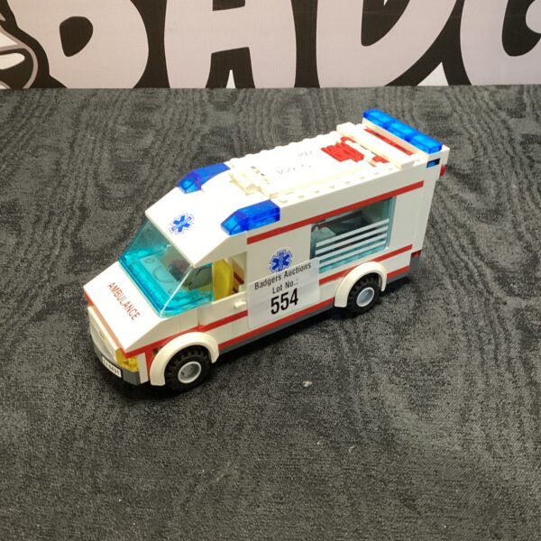 Red and white Lego ambulance model 4938, collectible toy vehicle.