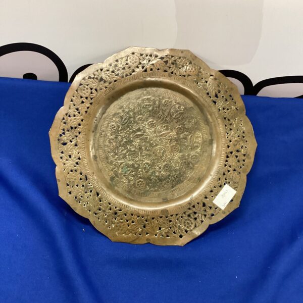 Intricate vintage Indian copper plate with detailed floral designs.