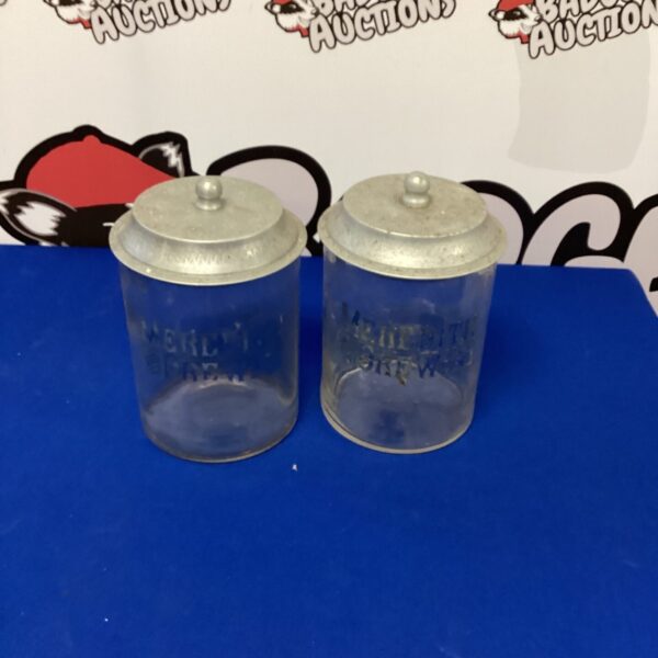 Pair of vintage ceramic biscuit barrels with embossed designs.
