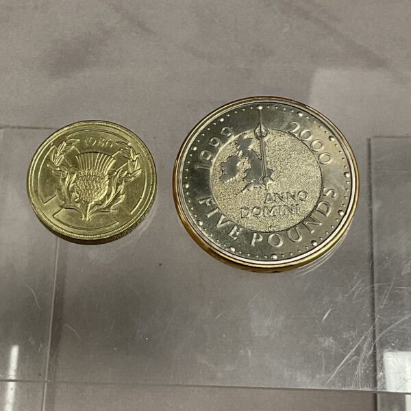 Millennium £5 coin and Commonwealth Games £2 coin pair.