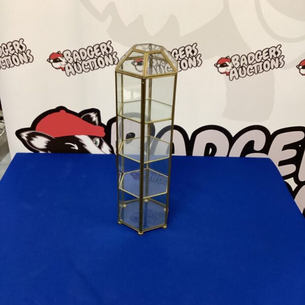 Vintage brass and glass display cabinet for collectibles.