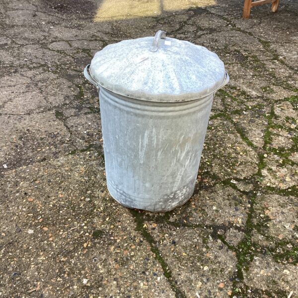 Vintage galvanised garden bin with lid, showing signs of wear.