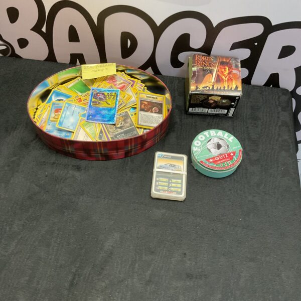 Mixed trading card collection including Pokemon and Lord of the Rings cards.