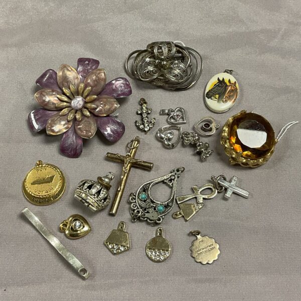 Vintage brooch and pendant lot with floral and geometric designs.