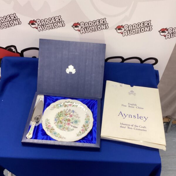 Vintage Aynsley cake plate and slice with floral pattern.