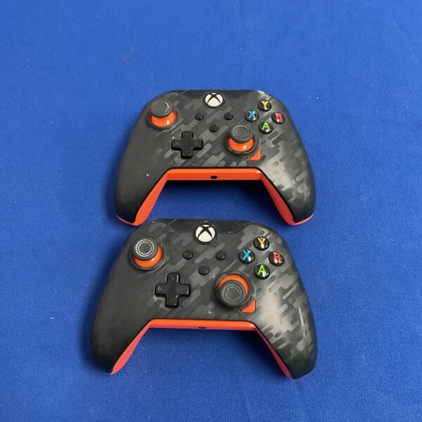 Pair of camouflage PDP Xbox One controllers for gaming.