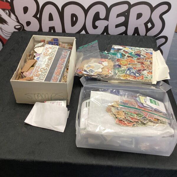 Large stamp collection with albums and a bag of vintage stamps.