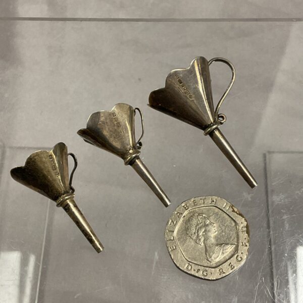Antique sterling silver perfume funnels with hallmarked details.