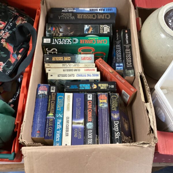 Lot of Clive Cussler adventure novels and thriller books.