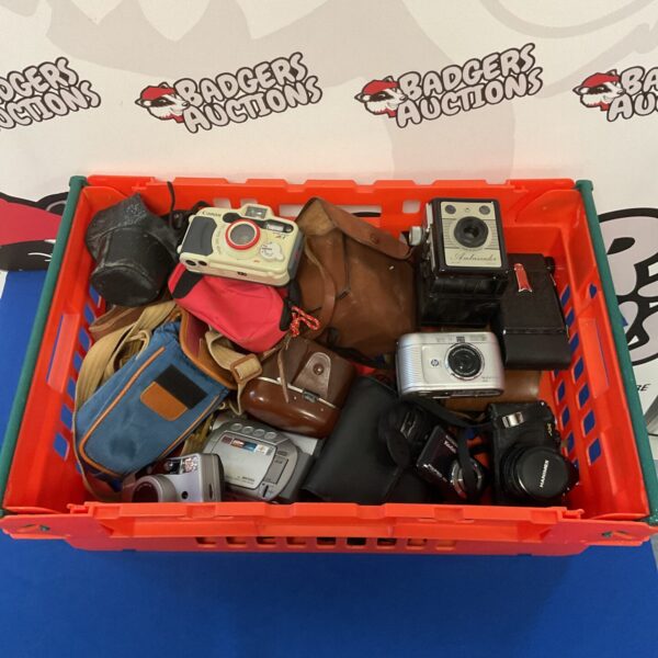 Tray of vintage cameras including Canon and Pentax models.