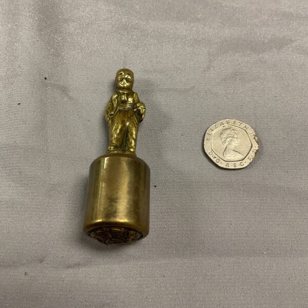 Antique brass figurine of a gentleman in period clothing.
