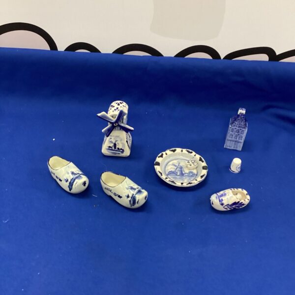 Delft pottery collection featuring a windmill and traditional Dutch shoe.