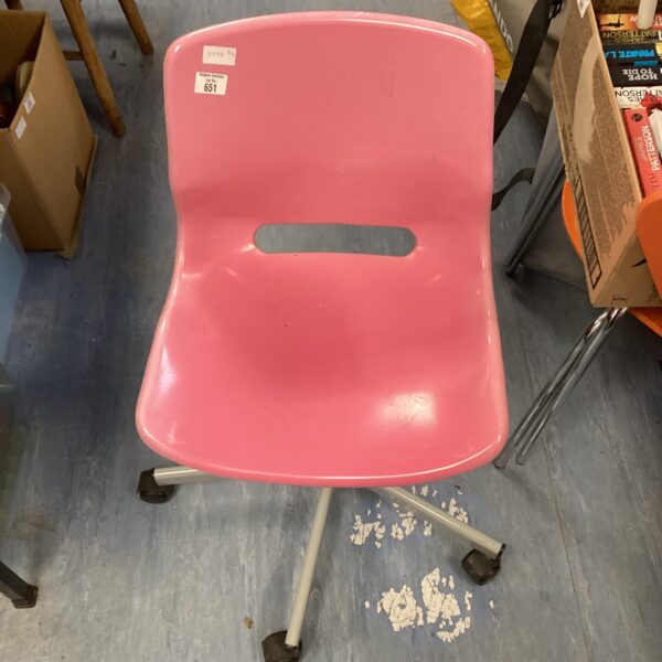 Vintage pink swivel chair with casters.