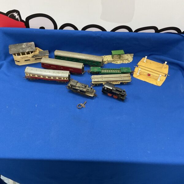 Vintage Triang Hornby train set with carriages and track sections.