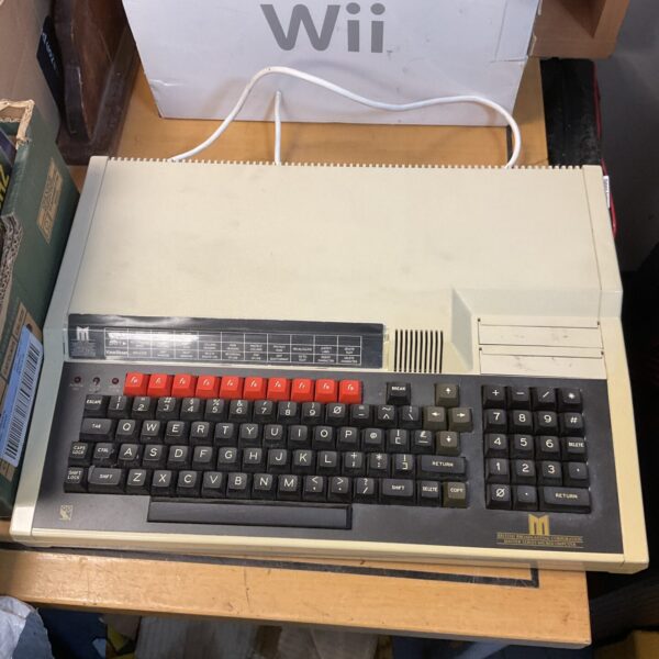 Front view of a vintage BBC Micro computer with keyboard.