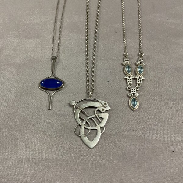 Silver Celtic pendant necklace with a blue teardrop stone.