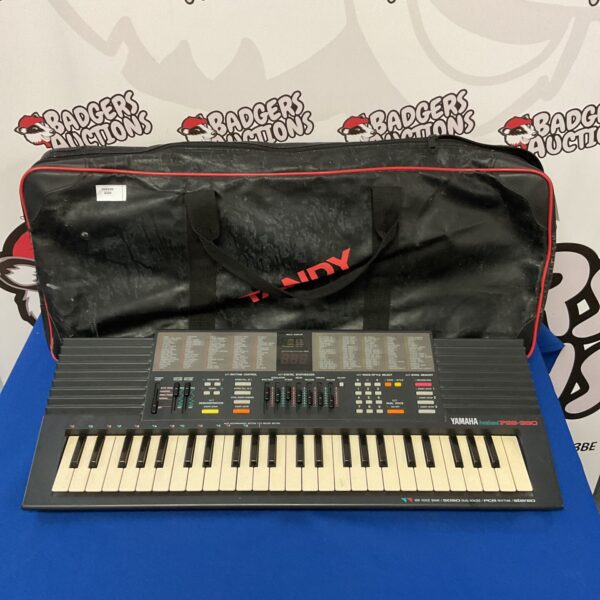 Vintage Yamaha PSS-390 keyboard with its original carrying case.