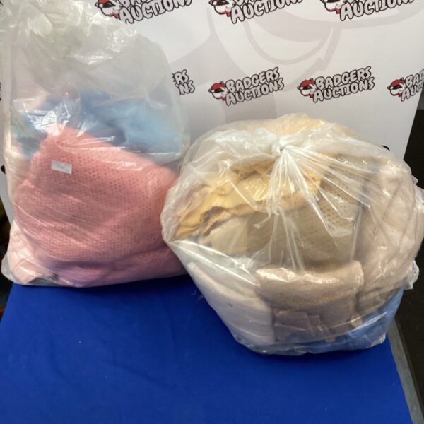Mixed blankets and towels in plastic bags, household textile lot.