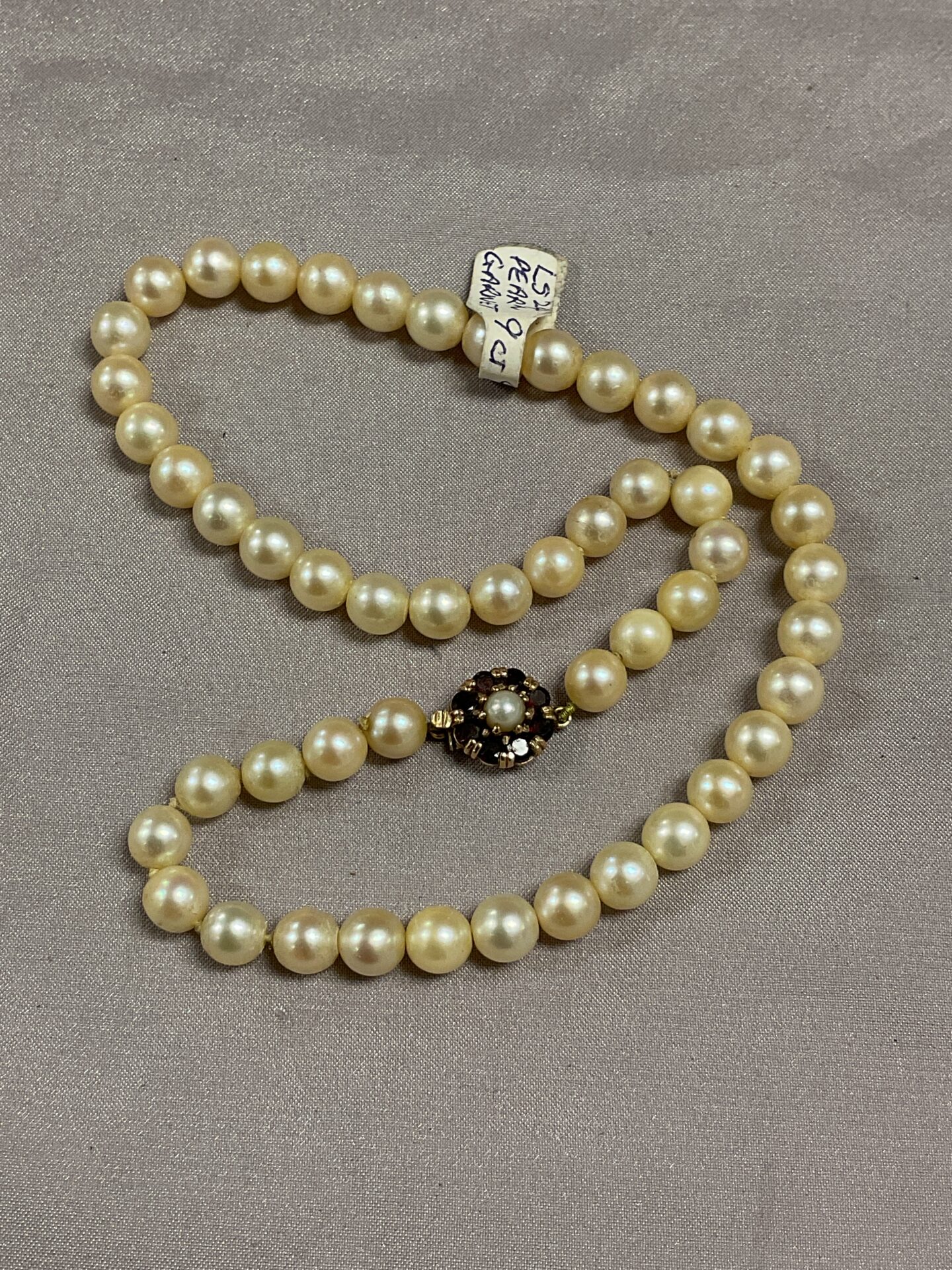 948 Cultured pearl necklace with 9ct gold garnet set clasp
