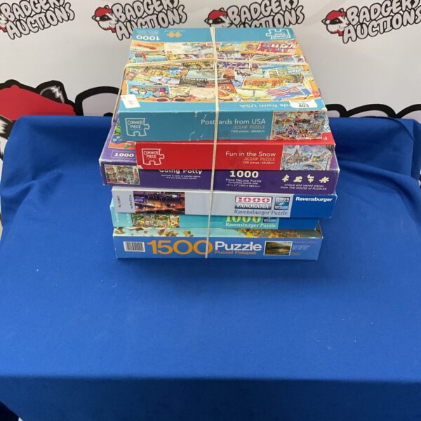 Mixed lot of jigsaw puzzles including Ravensburger and corner piece puzzle.