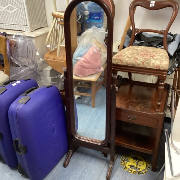 Ornate antique floor standing bedroom mirror with dark wood frame.