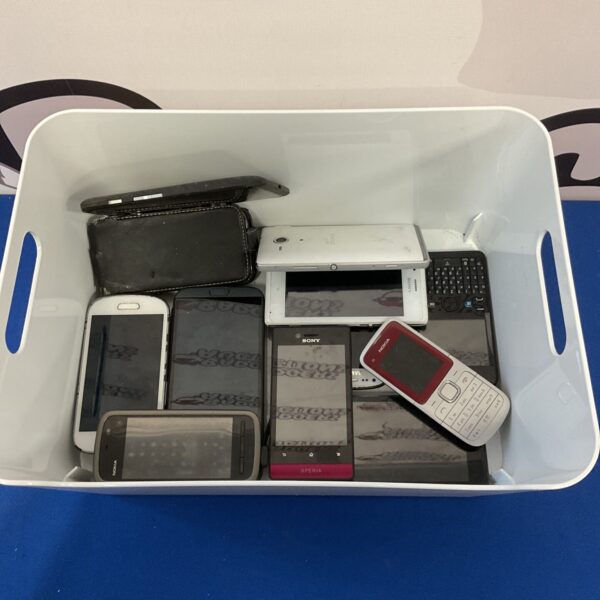Tray of vintage and retro mobile phones including Sony and Samsung handsets.