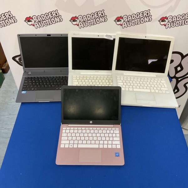 Lot of four used laptops for parts or repair.