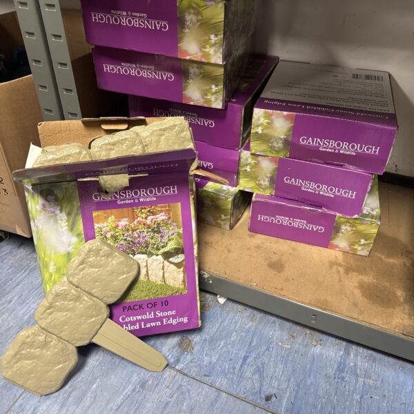 Stack of nine boxes of Gainsborough Cotswold stone effect lawn edging.