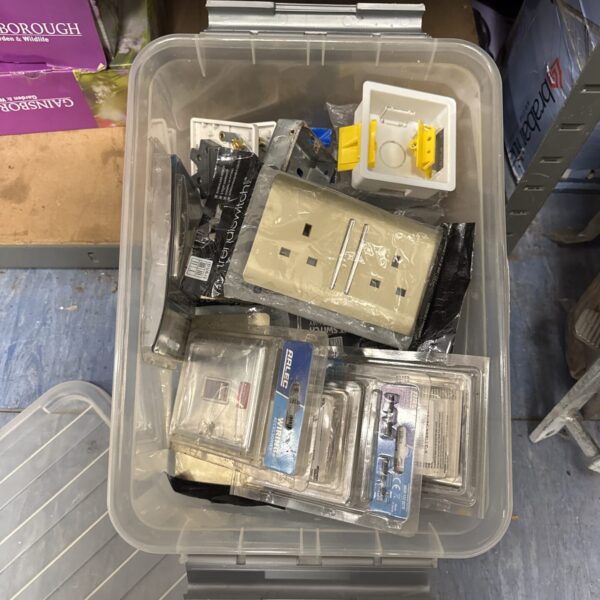Assorted electrical fixtures and switches in a box.