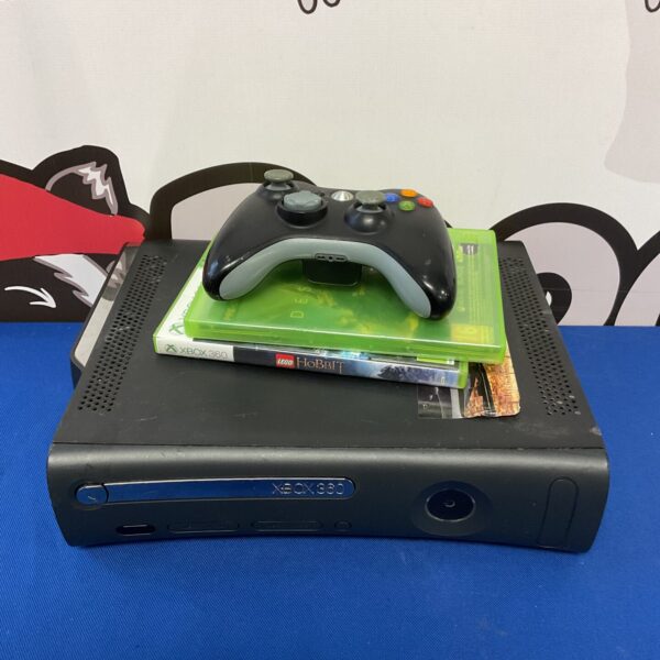 Microsoft Xbox 360 console with controller and games for retro gaming.
