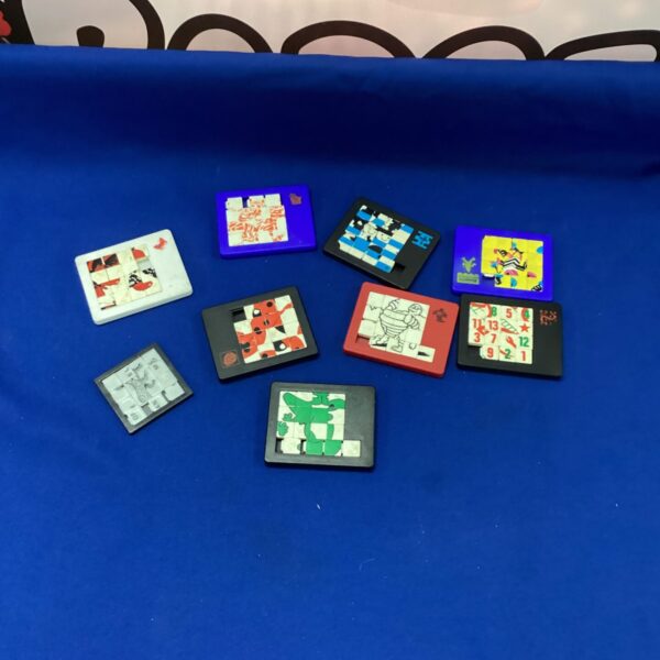 Vintage lot of sliding puzzles, including a Dodo brand puzzle.