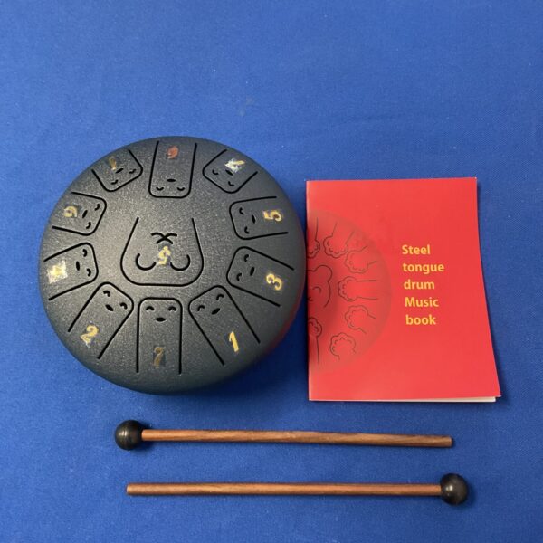 Steel tongue drum with mallets for calming meditation and music.