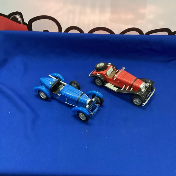 Vintage Burago model cars, Bugatti and Mercedes Benz displayed.